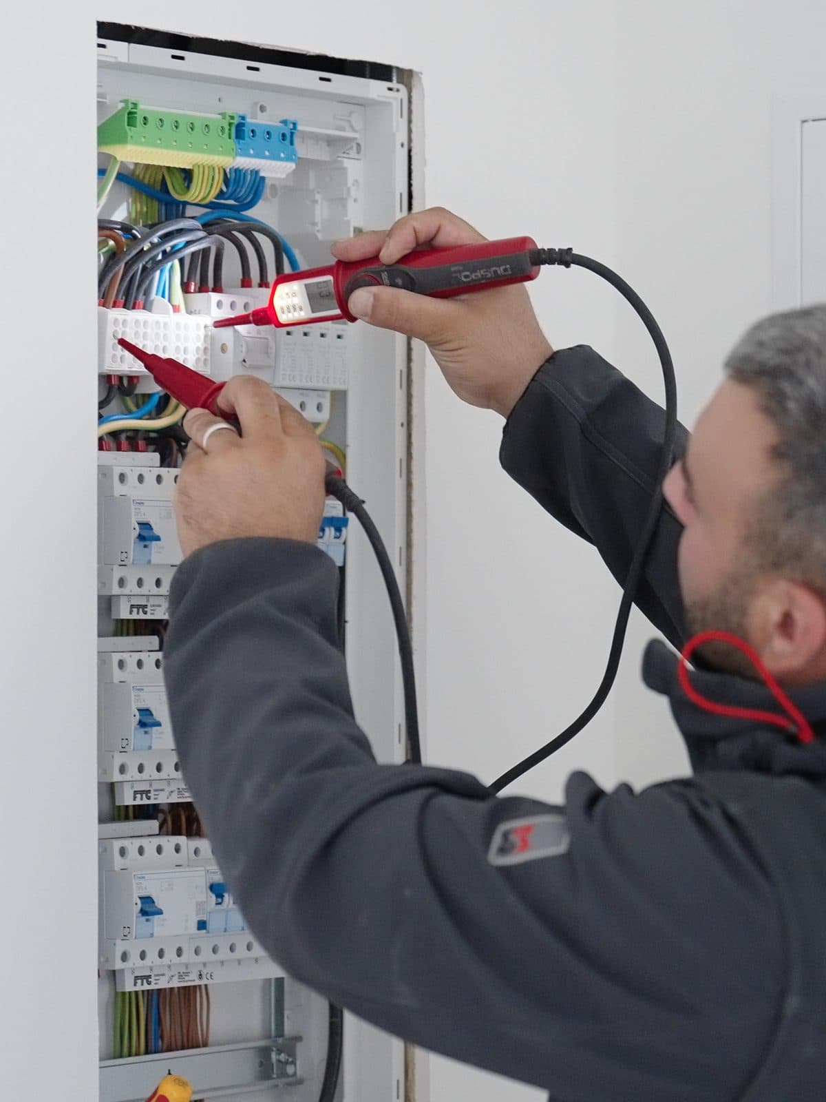 Electrician inspecting a newly installed distribution board