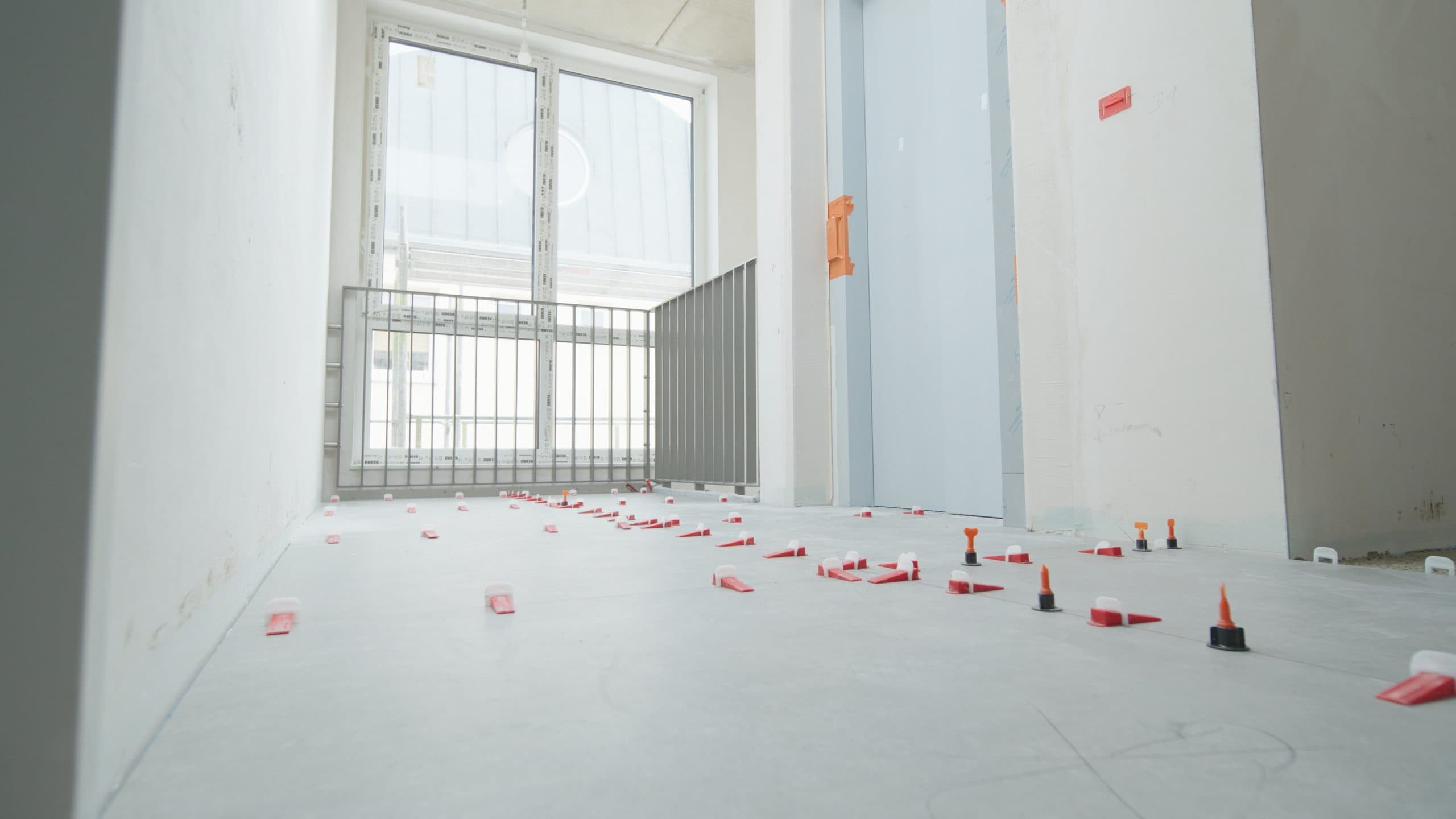 Interior during refurbishment with prepared floor and new window front